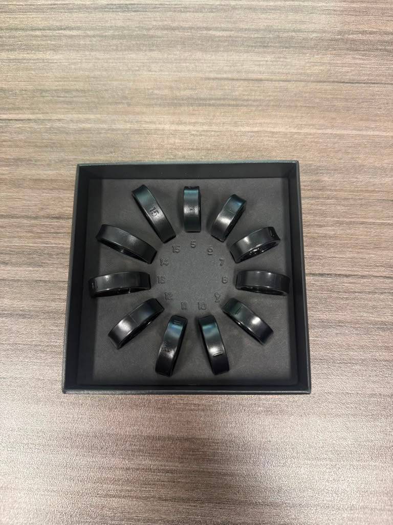 Assorted black rings displayed by size
